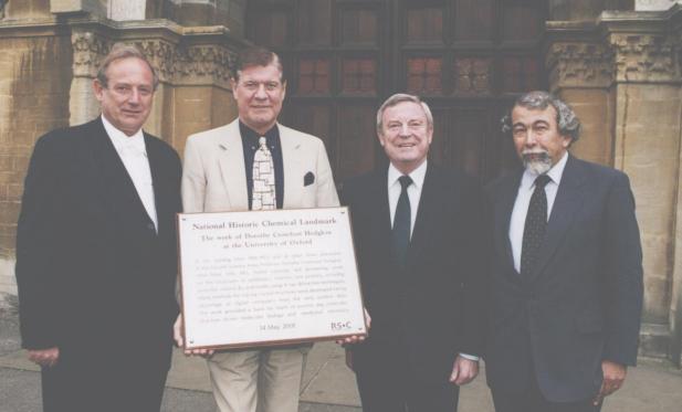 People presenting the plaque